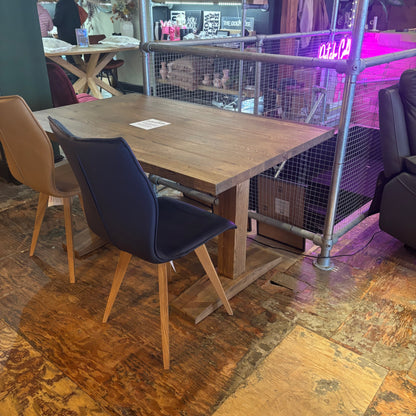 Wooden dining table with chairs in a casual setting